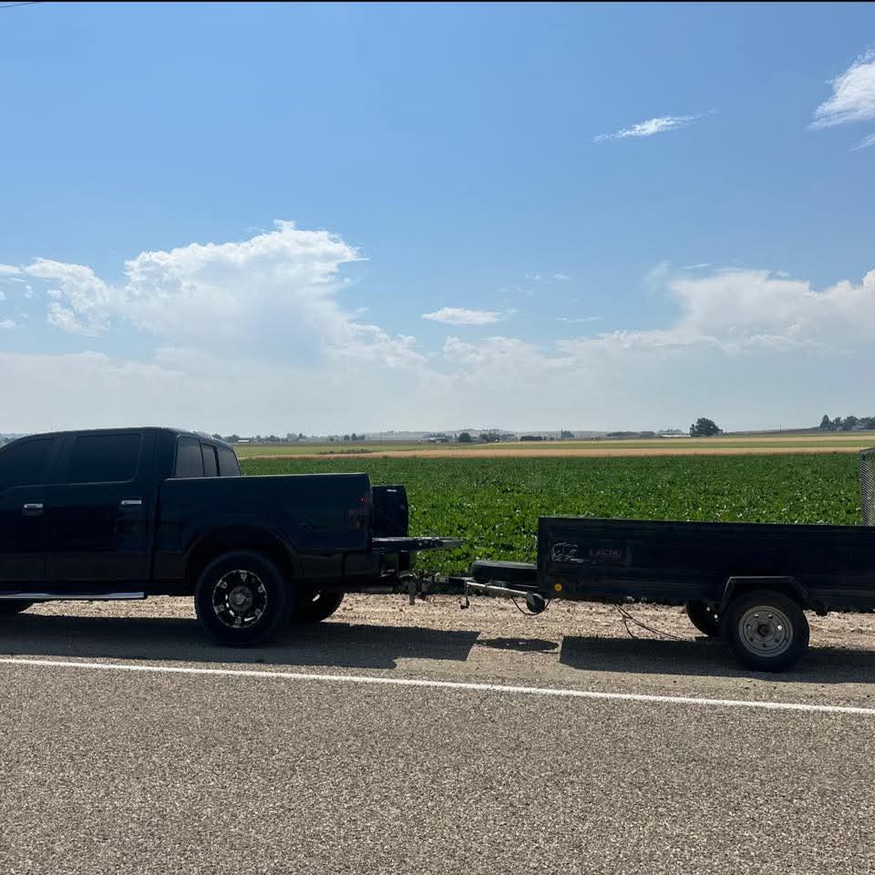 A to Z's black pickup and black trailer parked by an Idaho field under a big sky